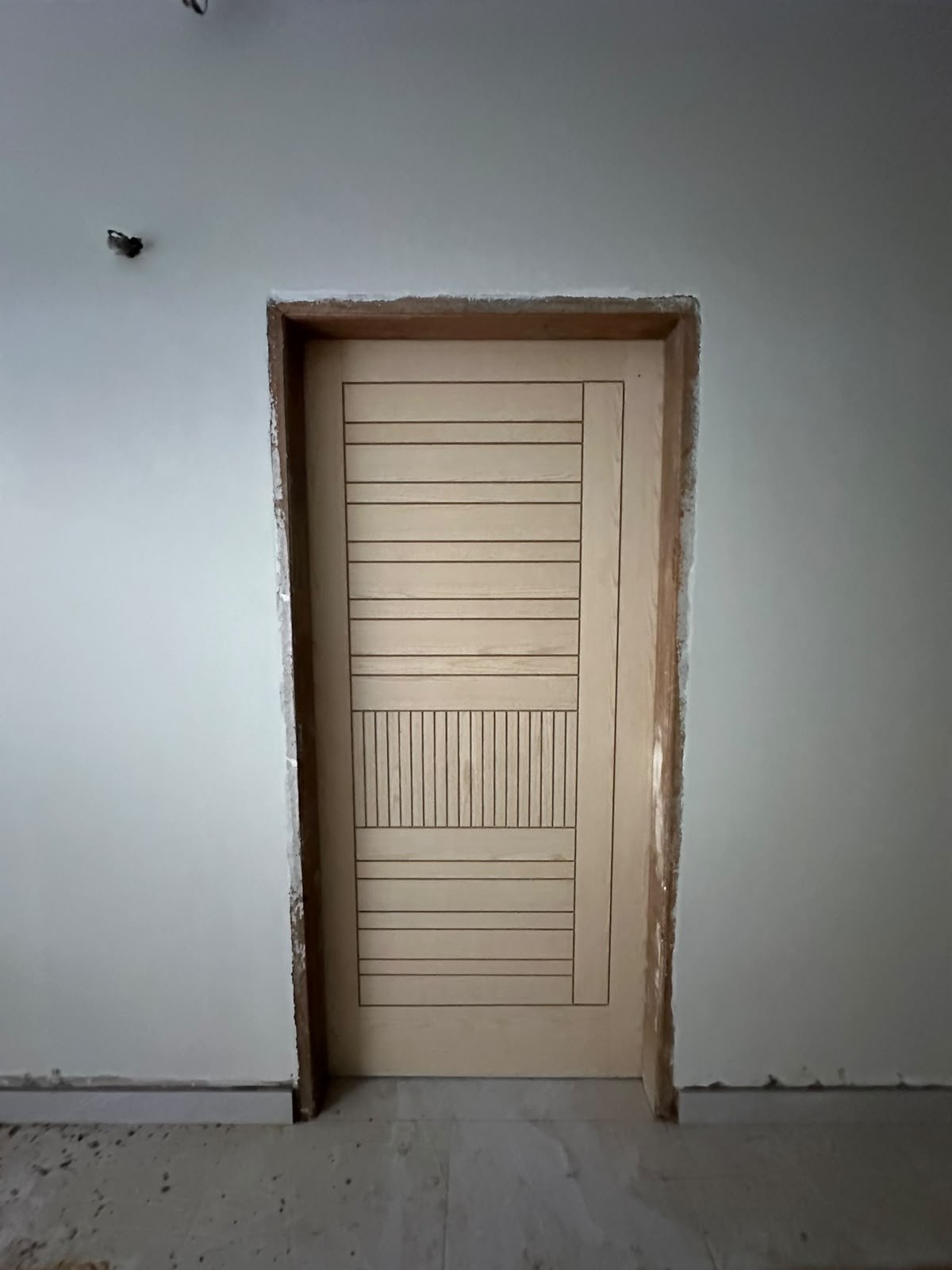 Timber door fitted in its frame before polishing