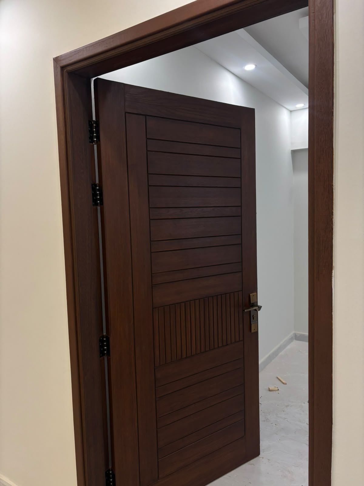 Polished timber entry door opening to a corridor